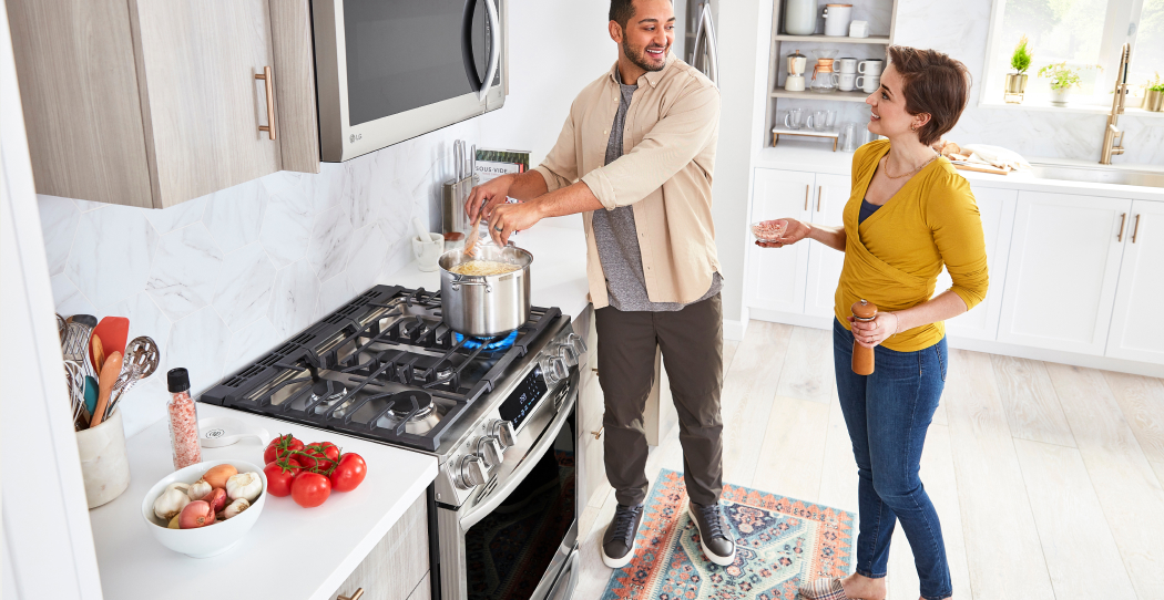 a man cooking pasta on a gas stove